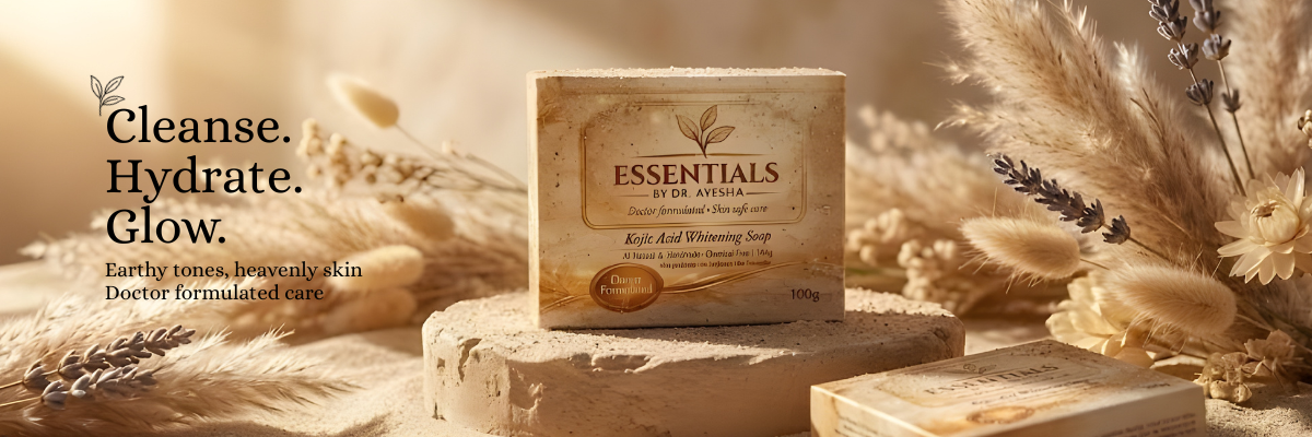 Bar of soap labeled 'Essentials' on a wooden block with natural elements like wheat and flowers in the background.